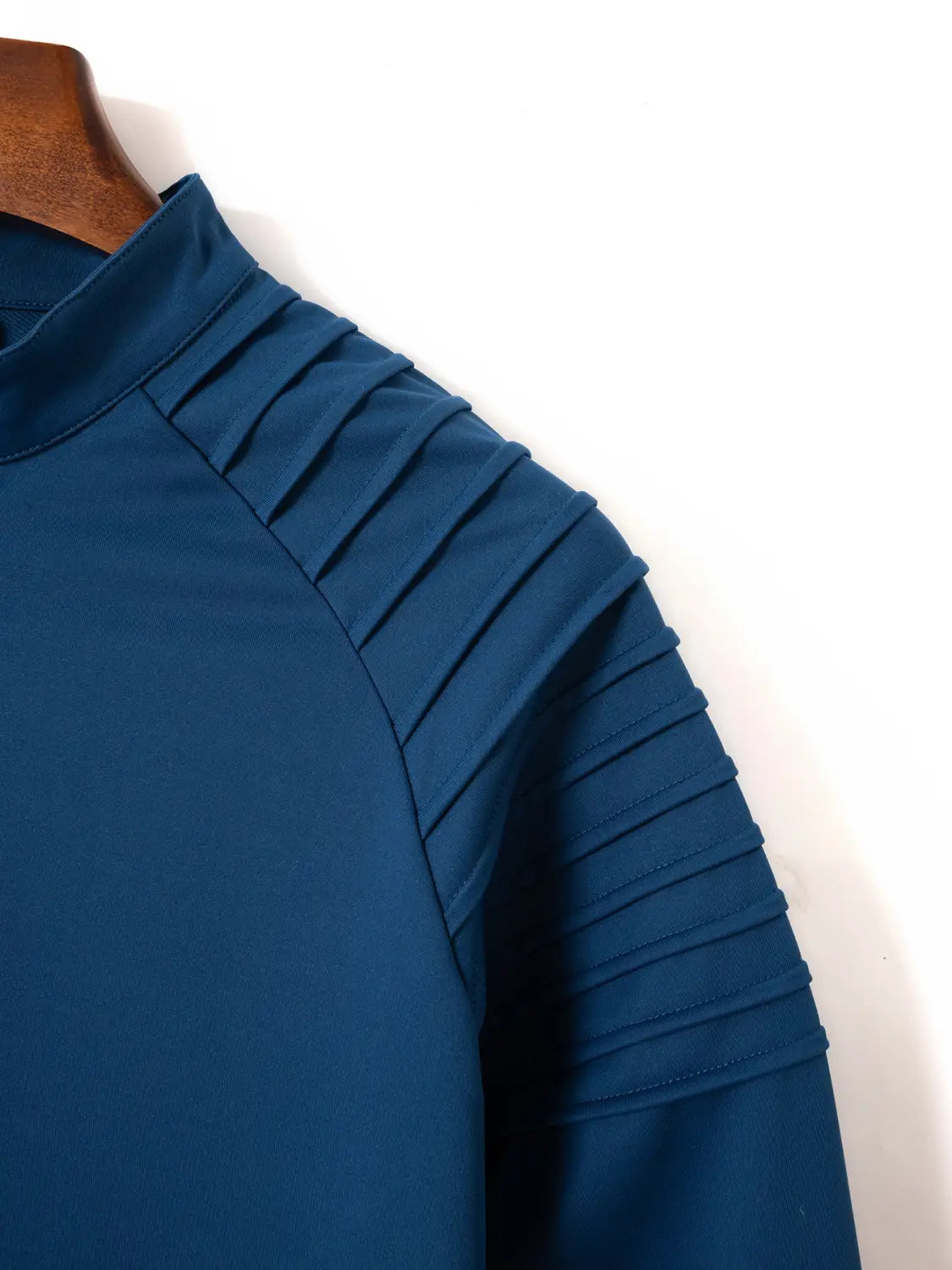 Dunkelblaues Herren-Quarter-Zip-Athletik-Poloshirt mit hohem Ausschnitt und plissierten Ärmeln.