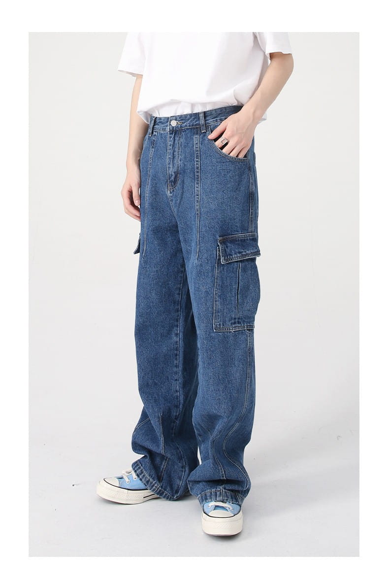 Blue denim cargo pants with large side pockets and a relaxed wide leg fit showcasing the retro loose fit wide leg denim cargo pants.