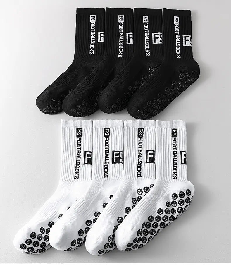 Black and white anti-slip football grip socks for men with textured grip soles ribbed cuffs and bold f logo and text branding.