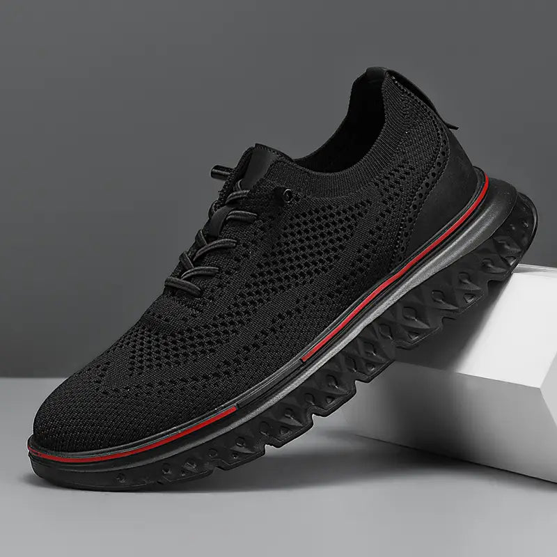 Men’s mesh knit casual lightweight sneaker in black with a red accent stripe along the sole.
