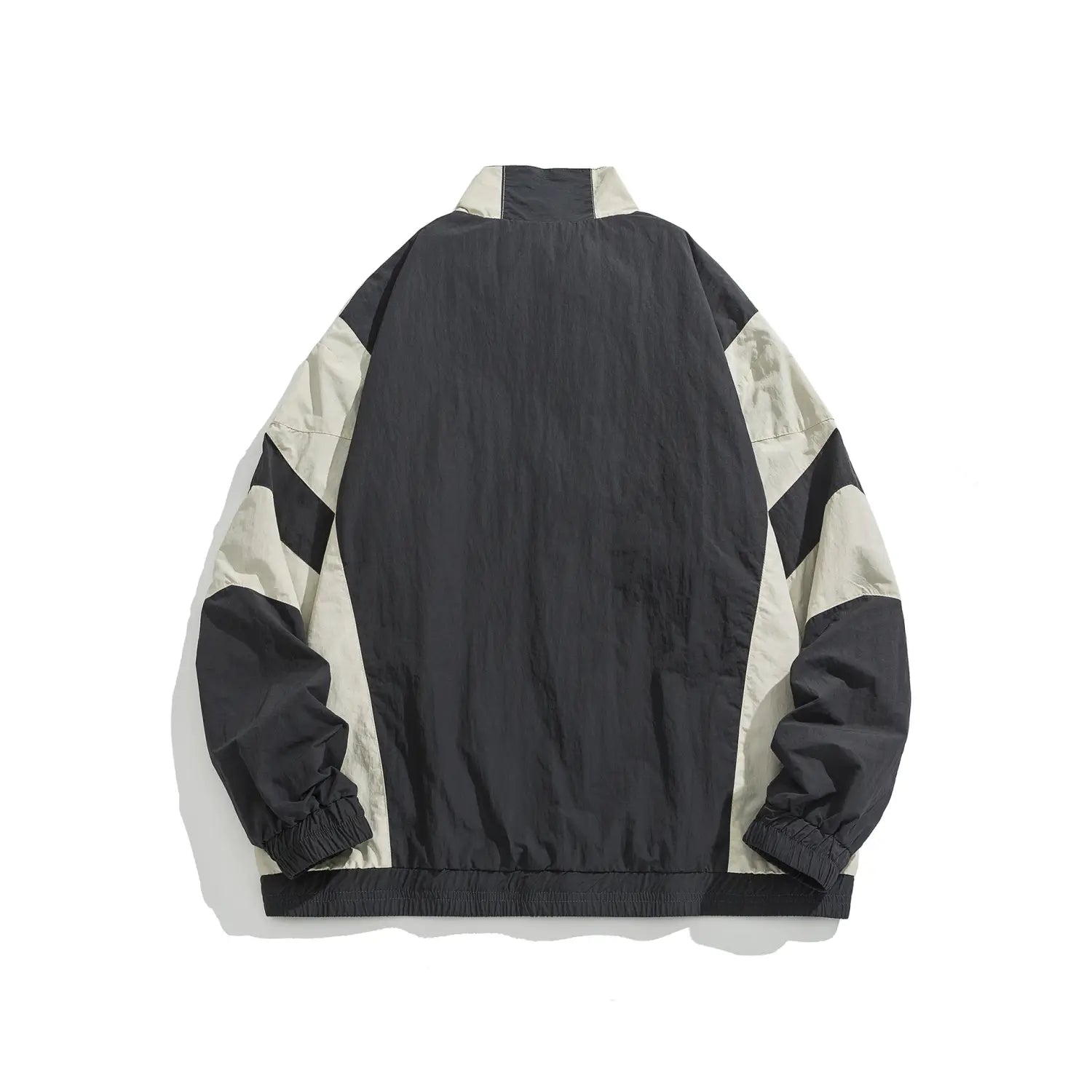 Veste coupe-vent ample à blocs de couleurs bicolores noir et beige, avec des détails brodés, un col montant élastique et des poignets élastiques, ainsi qu’un ourlet côtelé.