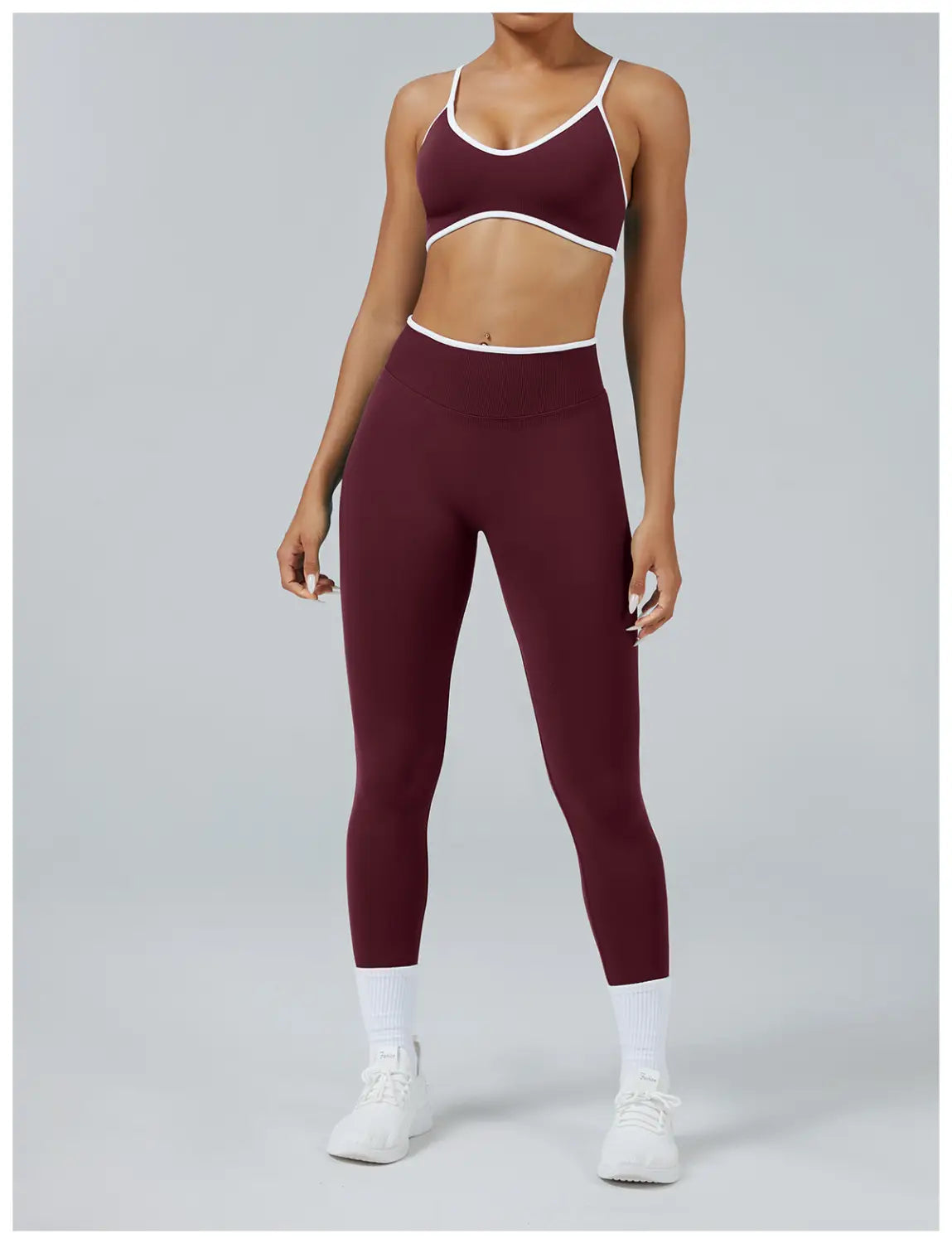 Maroon and white seamless high waist sports yoga leggings and matching crop top with thin straps in an athletic two-piece set.