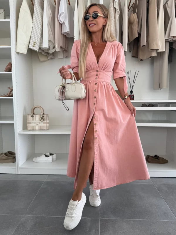 A soft pink button front midi dress with a v-neckline and three-quarter puff sleeves.