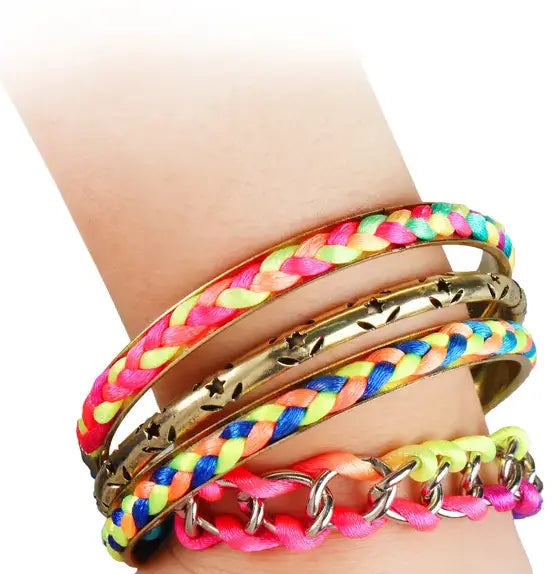 A vibrant neon braided gold bangle bracelet featuring neon pink yellow and blue threads woven in a tight pattern with star accents.