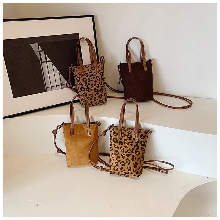 Retro leopard print suede mini bucket crossbody bags with brown leather handles and adjustable straps.