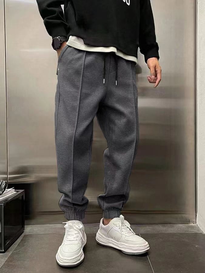 Men’s fleece drawstring sweatpants in gray with a drawstring waist and elastic cuffs designed for comfort and casual wear.