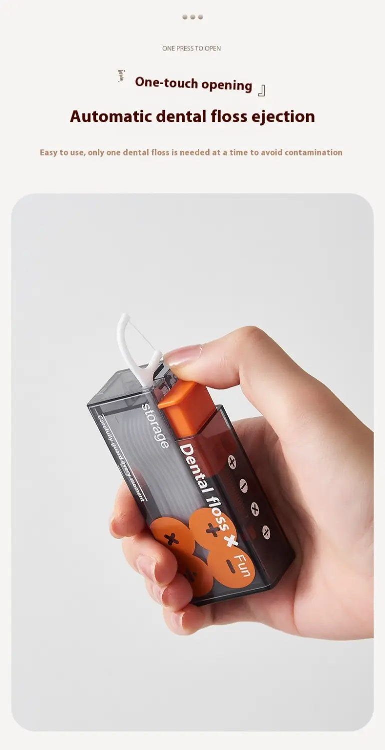 Dispensador automático de apertura emergente para caja portátil de hilo dental en negro y naranja transparente, con un diseño moderno y elegante para un uso conveniente en el cuidado dental.