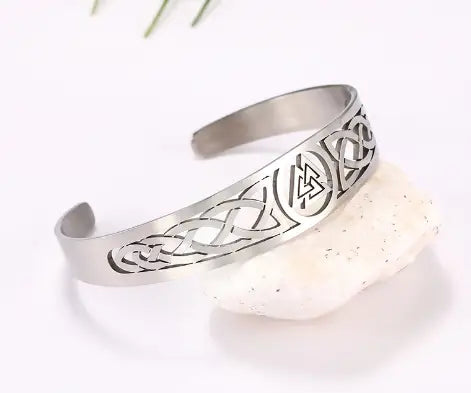 Silver-toned stainless steel cuff bracelet featuring intricate celtic knotwork and a central valknut triangular symbol.