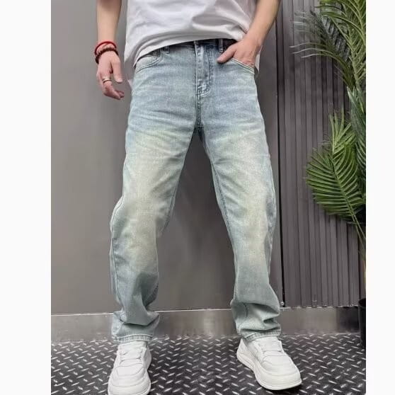 Men’s light wash relaxed straight leg denim jeans featuring a faded distressed look and classic five-pocket design.