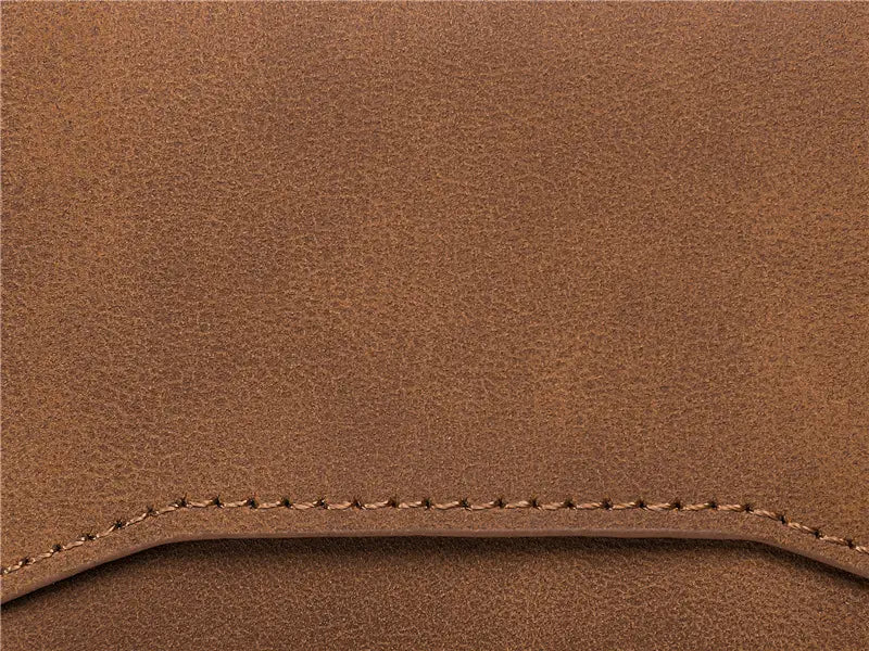 Brown leather crazy horse leather metal card case wallet with visible stitching along the edge.