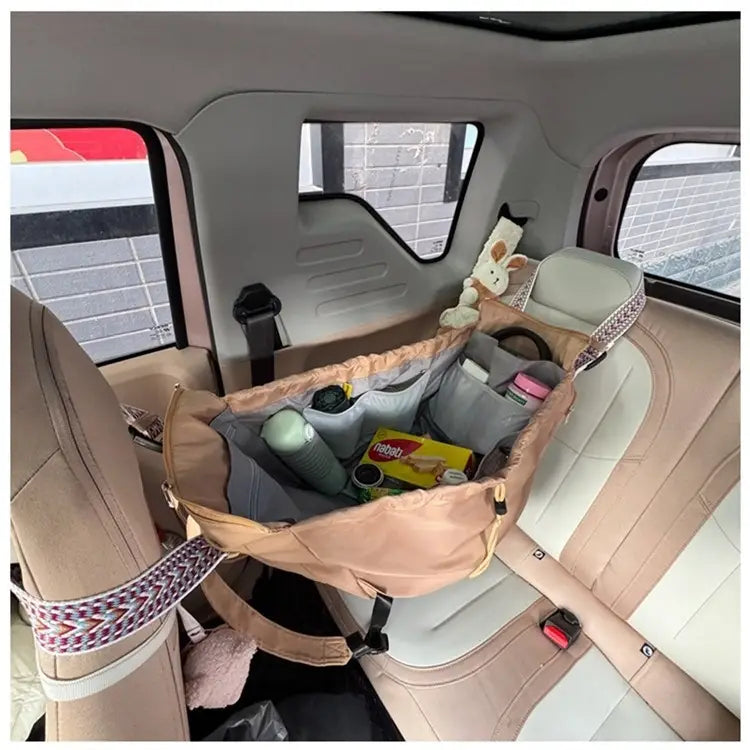 beige and gray fabric car seat organizer with patterned straps shown on the back side of a multifunctional waterproof nylon fashion tote and backpack.