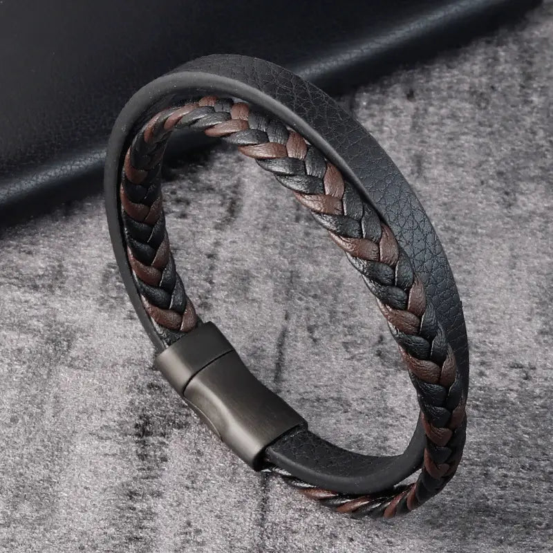 men’s braided leather bracelet with magnetic clasp in black and brown colors featuring intertwined leather strands.