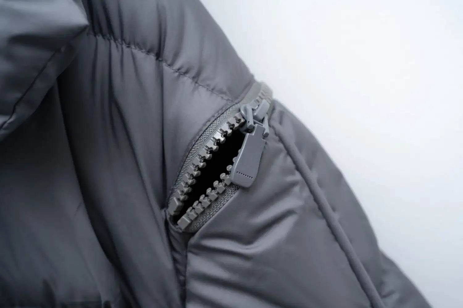 Dark gray down jacket patchwork with large lapel in Korean style featuring a silver-toned zipper and textured puffer fabric.