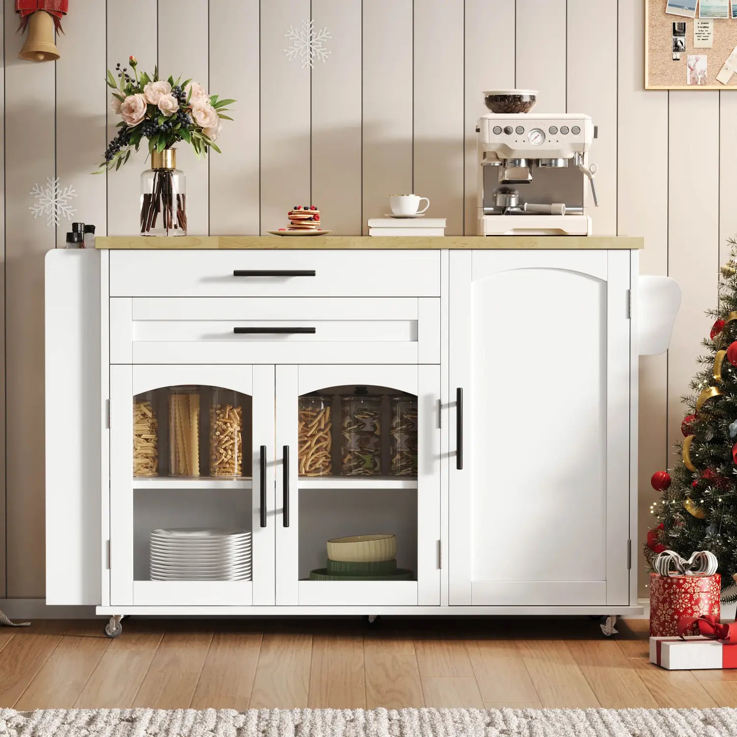 White mobile kitchen island with foldable light wood countertop, glass-paneled doors, black handles, and wheels for easy mobility.