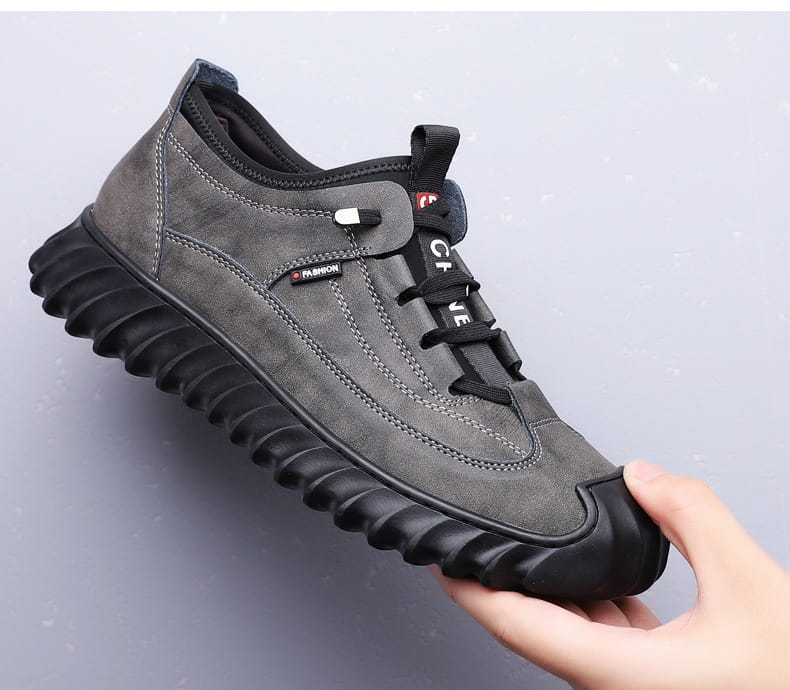 Men’s suede casual sneaker in gray with black laces and a chunky textured rubber sole.