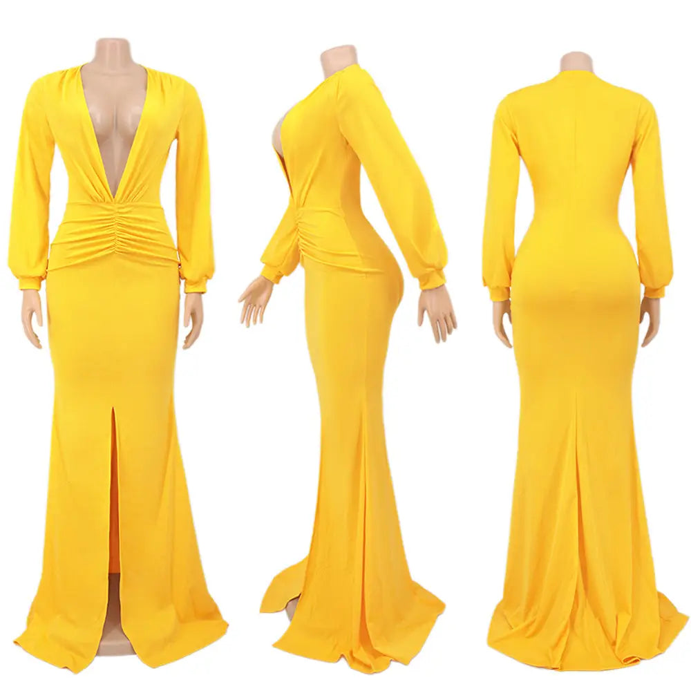 A vibrant yellow velvet v-neck evening dress featuring long sleeves, a mermaid silhouette, deep v-neckline, and ruched waist detail.