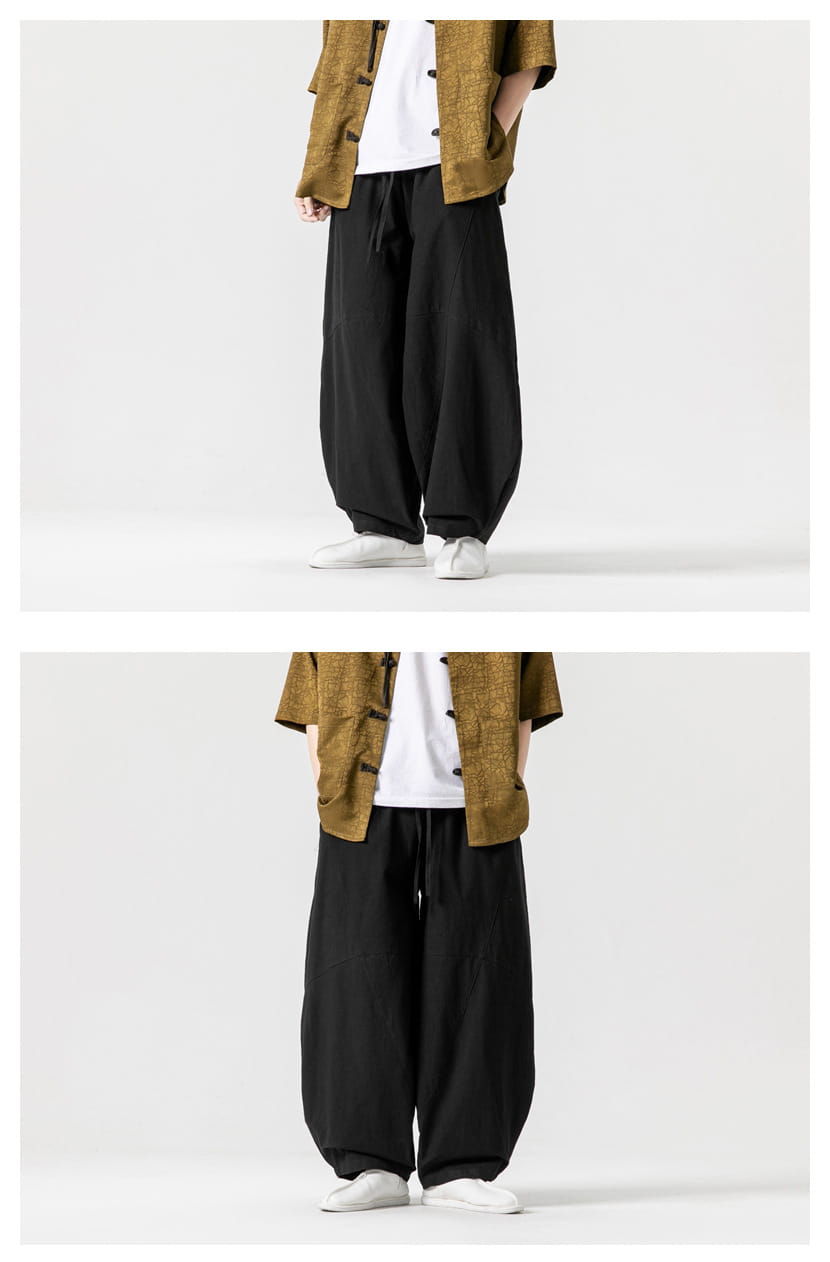 Pantalon ample en toile de tai-chi en coton noir, coupe ample, avec taille à cordon, pour un port décontracté et confortable.