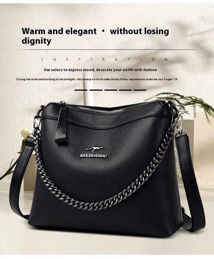 Black leather crossbody handbag with silver chain strap featuring the baileidai shu logo.