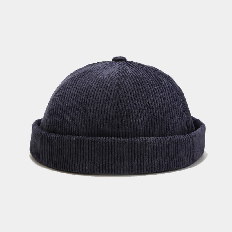 Dark navy corduroy landlord beanie with a ribbed texture and folded brim adjustable for streetwear use.