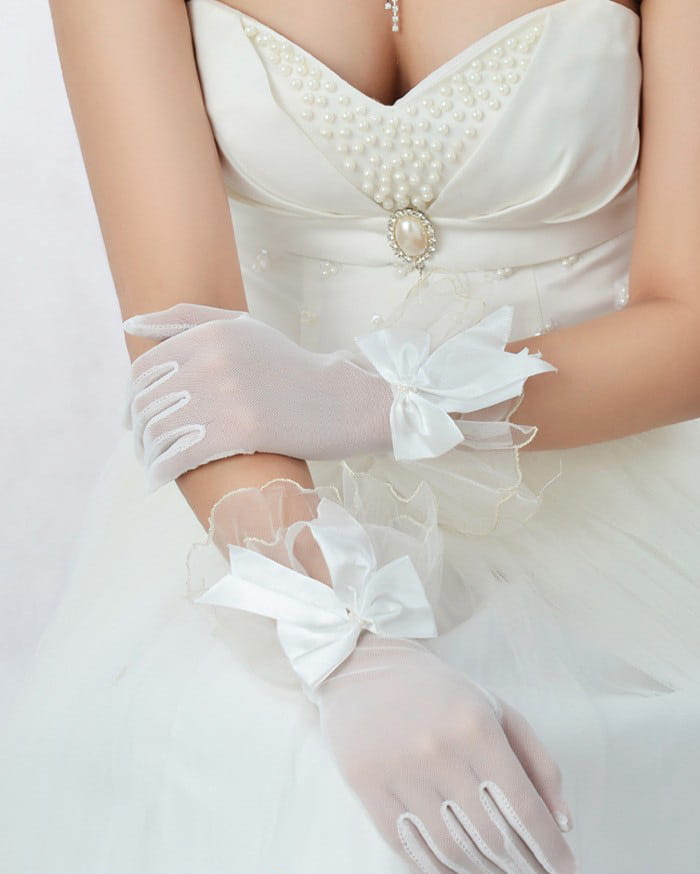 Elegant black lace evening gloves with delicate white organza material and matching satin bows at the wrist.