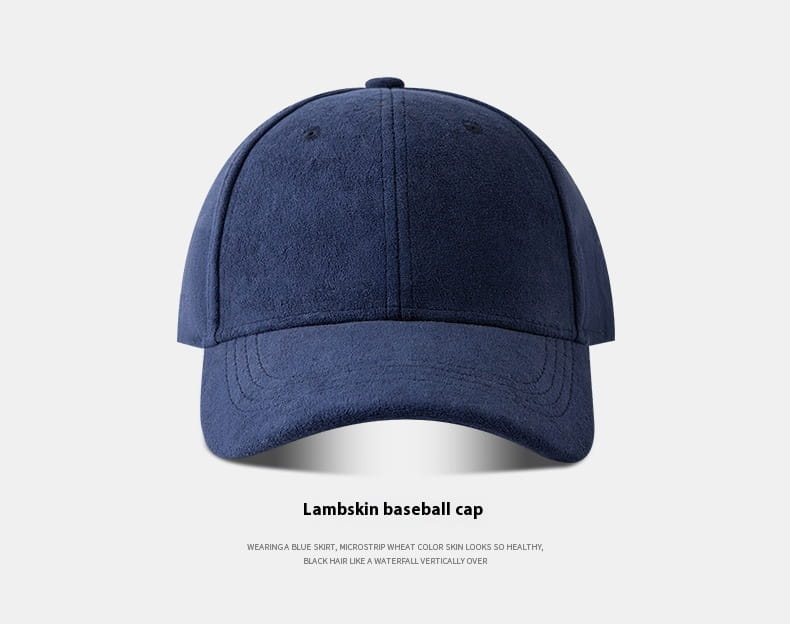 Navy blue lambskin suede baseball cap with a structured crown, curved brim, and adjustable strap, designed as a soft minimalist hat.