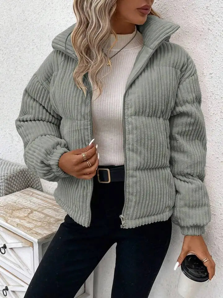 A cozy light green corduroy puffer jacket with a hood and front zipper designed as a plus size women winter coat.