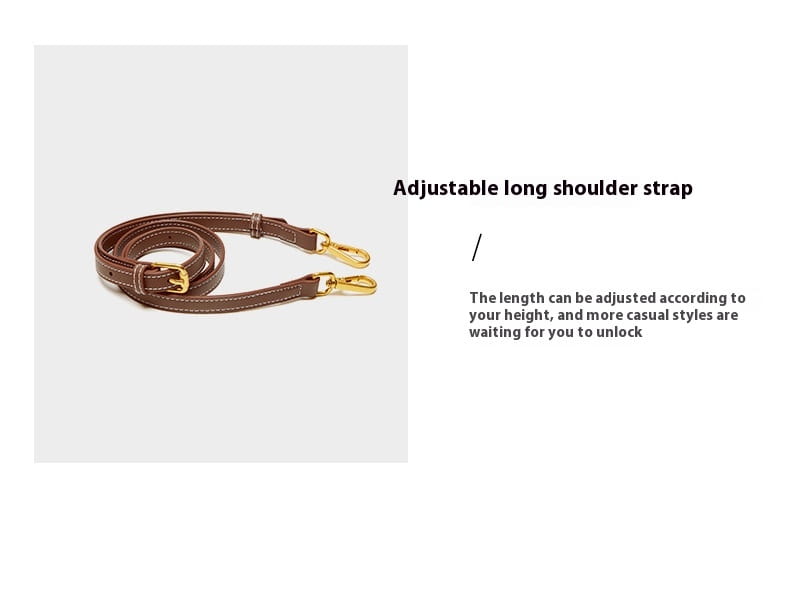 Verstellbarer Schulterriemen aus braunem Leder mit goldtönigem Metallbeschlag an einer zweifarbigen Webleder-Crossbody-Handtasche mit goldfarbenen Beschlägen