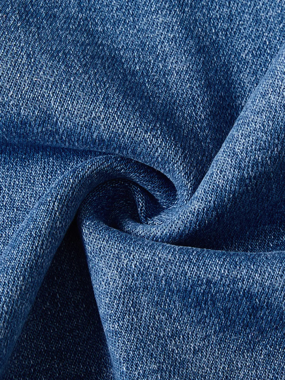 Wide leg stretch denim jeans feature blue denim fabric with a textured woven pattern and subtle variations in shade.