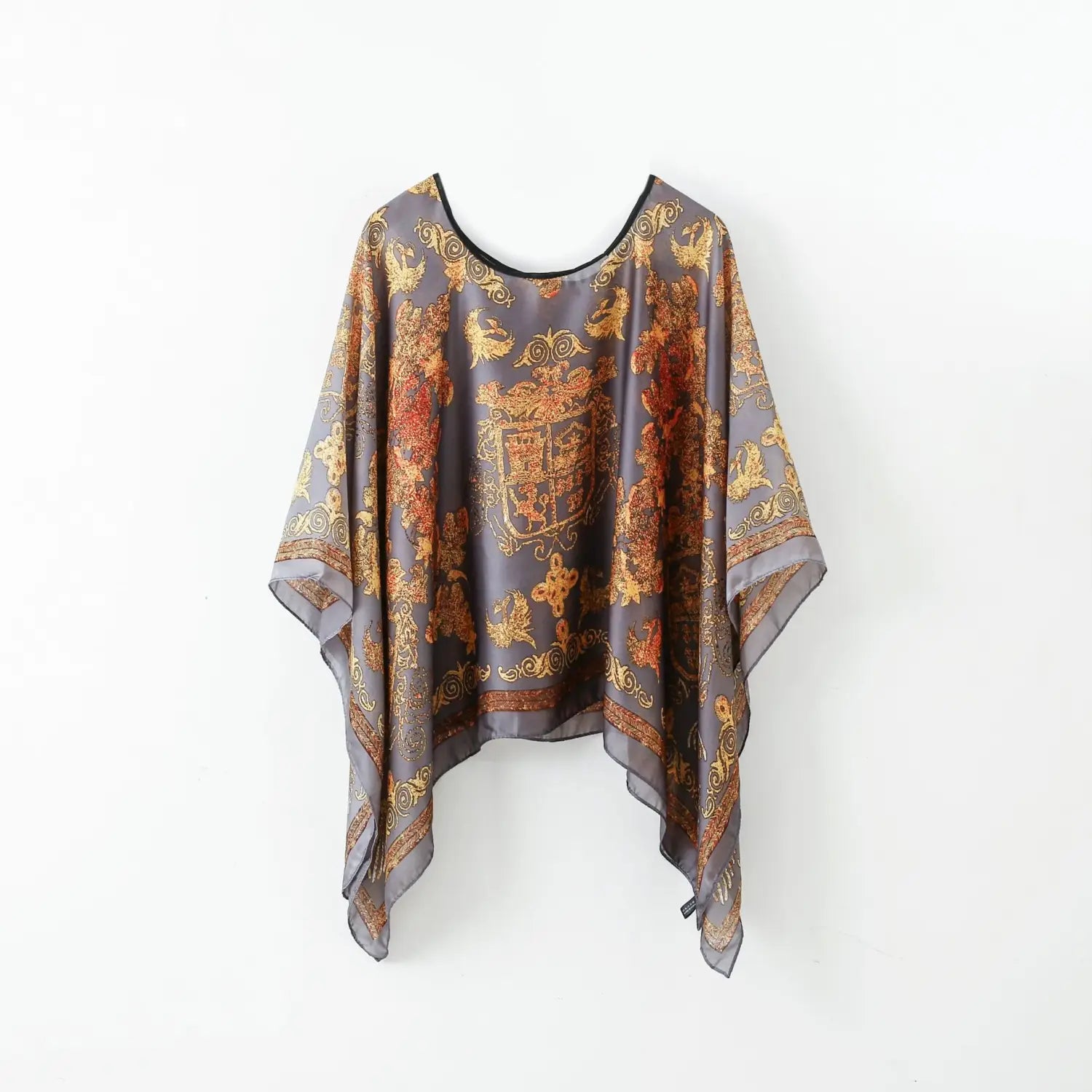 A flowing gray silk pullover shawl cape outerwear with an ornate gold and rust-colored baroque-inspired printed pattern.