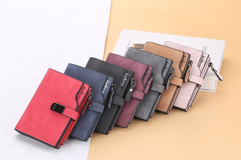 A collection of women’s short faux leather multi slot wallets in compact matte finish with multi-colored options zipper closures and branded embossed details.