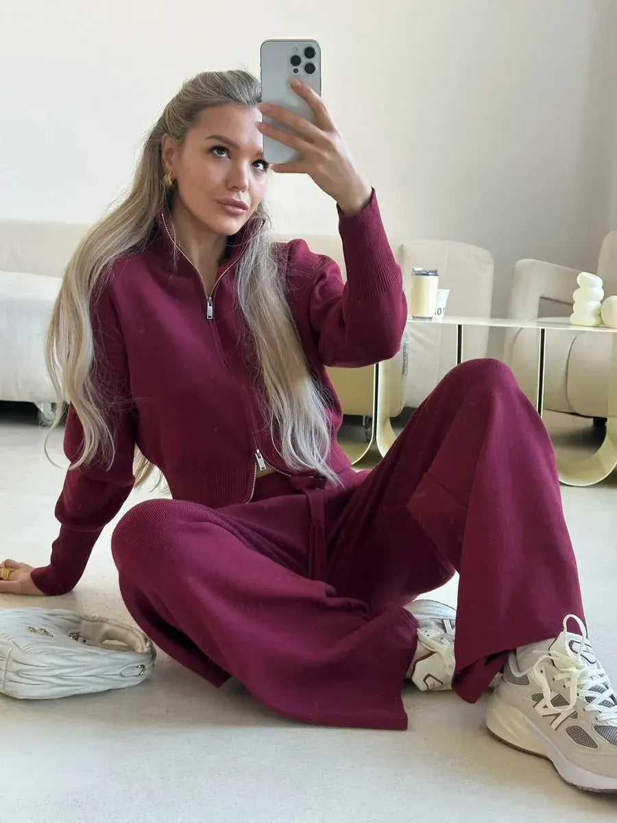 Women’s maroon knit zip up cardigan and wide leg pant set featuring a zipper front and long sleeves made from comfortable knit fabric.
