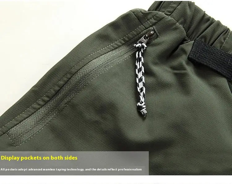 Olive green convertible tactical hiking pants featuring a black elastic waistband and a braided black and white cord zipper pull.