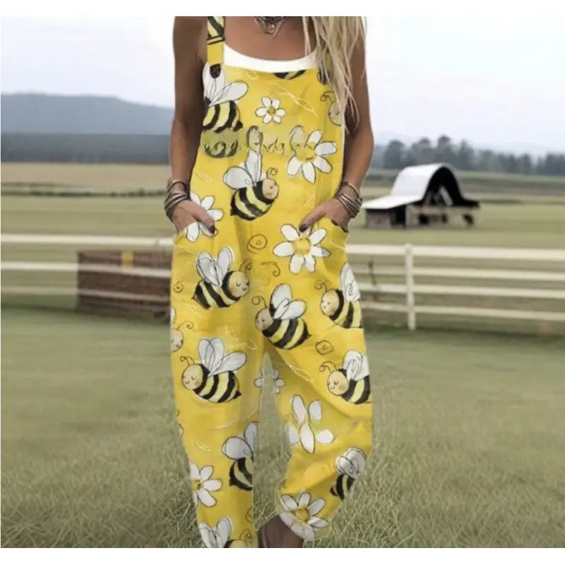 yellow printed suspender overalls casual pants featuring a playful pattern of cartoon bees and white daisies on a soft fabric.