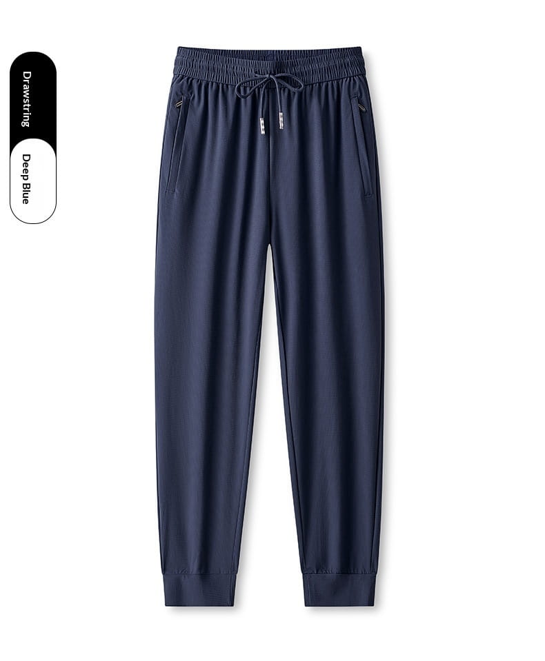 Deep blue ice silk antibacterial casual sweatpants with a smooth lightweight fabric, elastic waistband, drawstring, and tapered legs.