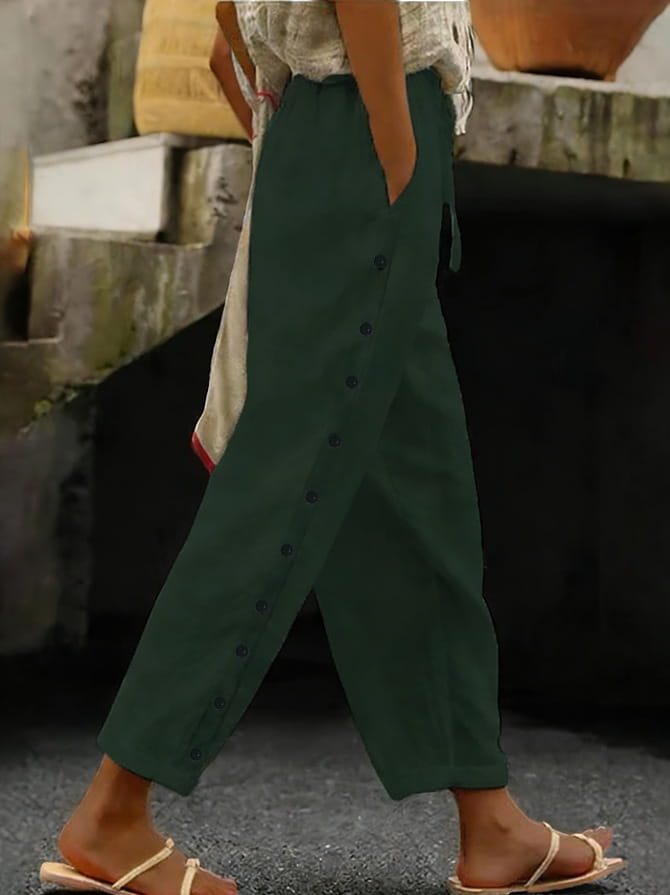 dark green cropped patchwork casual pants for women featuring loose fit and button details down the side