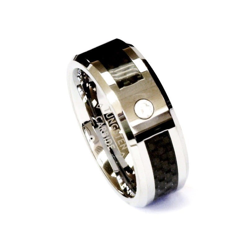 A sleek modern black tungsten wedding ring with a green aluminum 8mm band featuring a bold black carbon fiber inlay and a single embedded diamond accent.