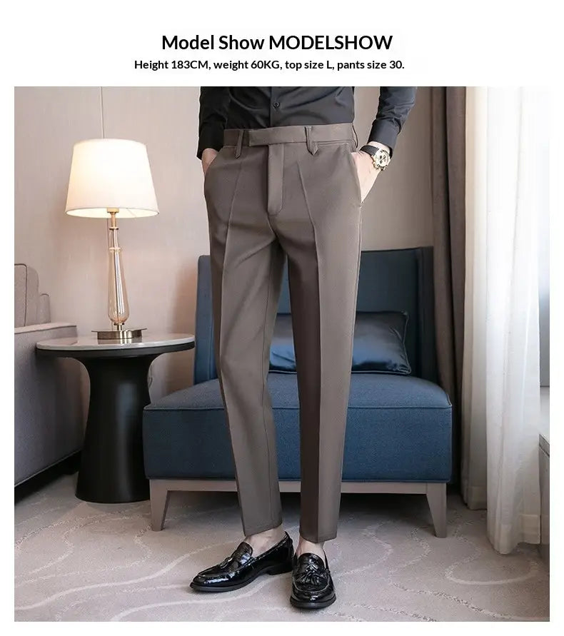 A pair of men’s slim fit British style gray tailored trousers with a modern cut and subtle pleats at the waist.