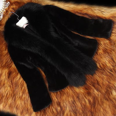 Black padded women’s coat with a plush black faux fur collar and long sleeves designed for winter use.