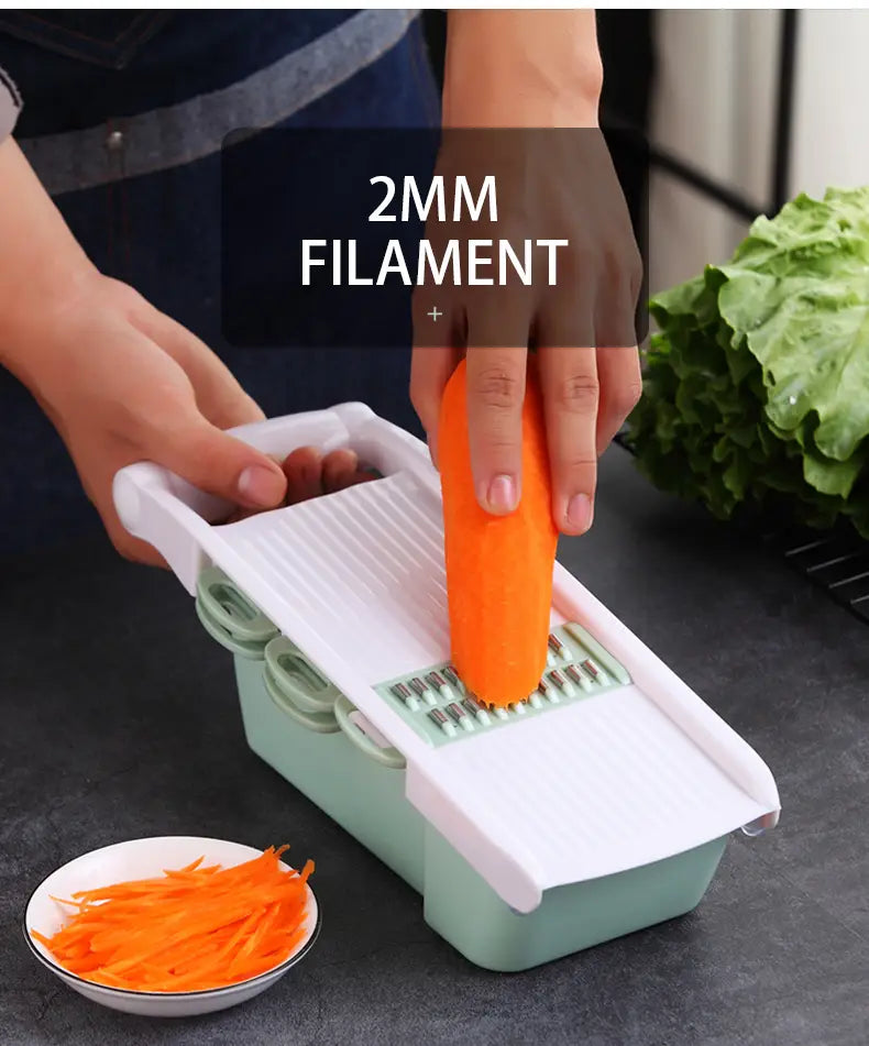 White and mint green plastic vegetable slicer mandoline grater with interchangeable 2mm filament blades for precise slicing and grating.