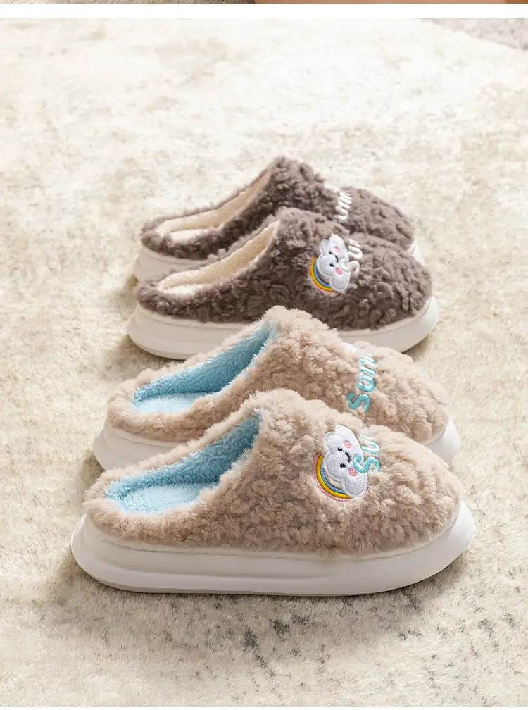 beige and brown plush cotton slip-on slippers featuring embroidered smiling cloud and rainbow designs.