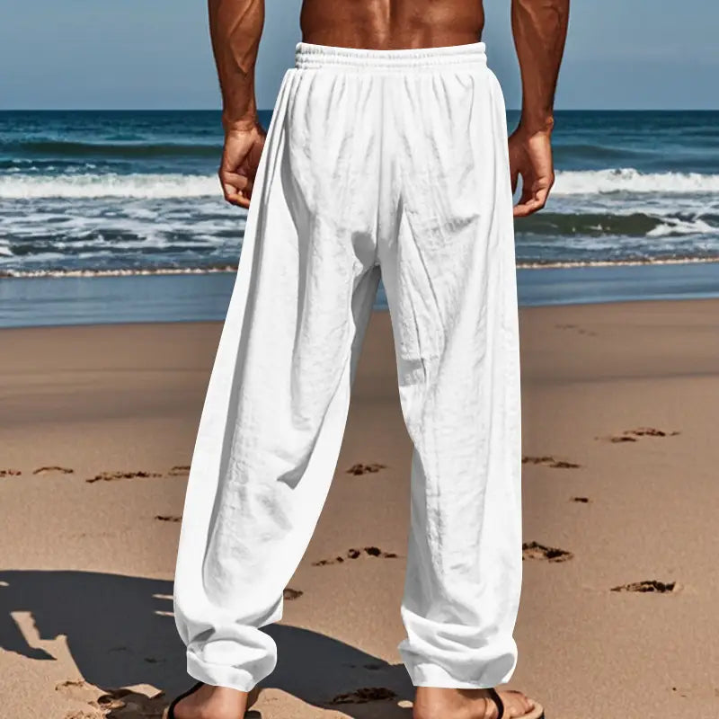 White loose-fitting cotton joggers with elastic waistband and cuffed hems designed as casual mens linen drawstring pants.