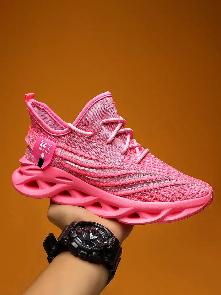 Vibrant pink flyknit mesh platform running shoe for men with knit upper, bold sculpted sole, and matching laces.