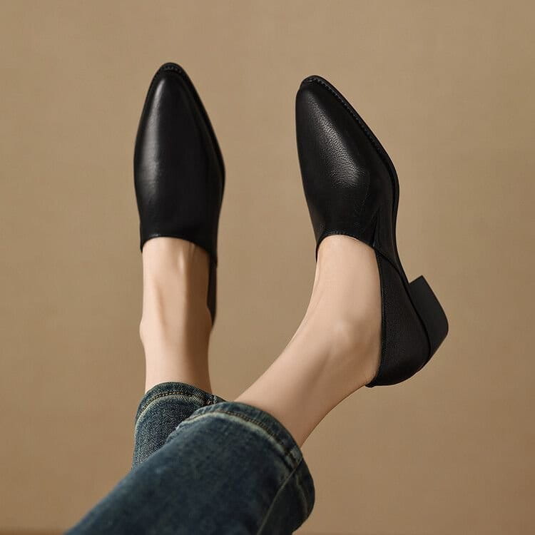 Black leather pointed-toe loafers with a low block heel for women made of leather.