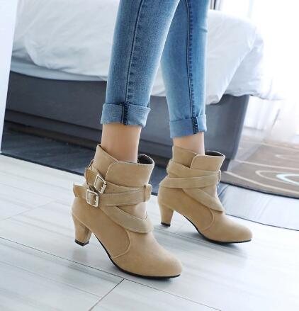 Botines de ante de cuero color beige con tacón de bloque color dorado tipo pump con dos hebillas de correa ajustables.