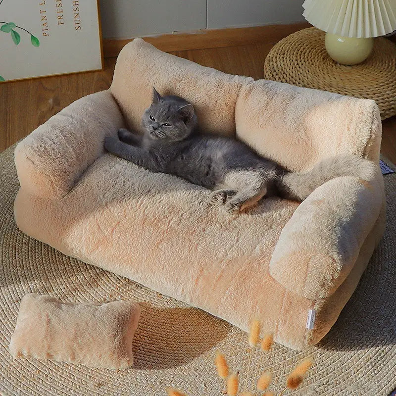 Beige plush cat sofa bed featuring a soft fluffy texture and rounded armrests designed as a warm winter pet lounger.