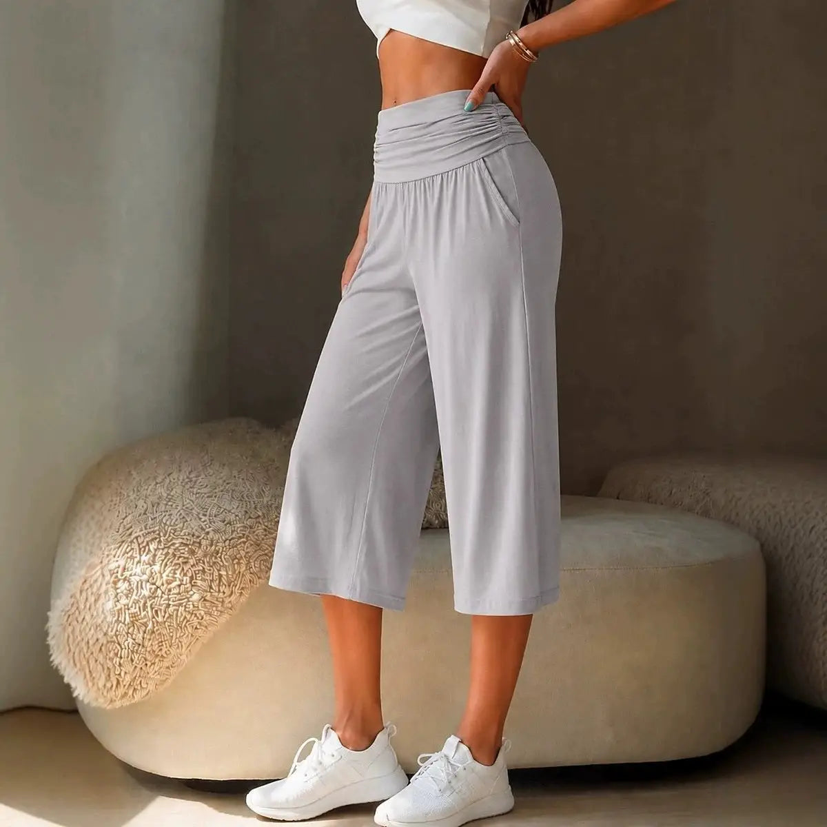 Light gray high-waisted wide-leg cropped pants made of soft stretchy fabric with subtle side pockets for casual wear.