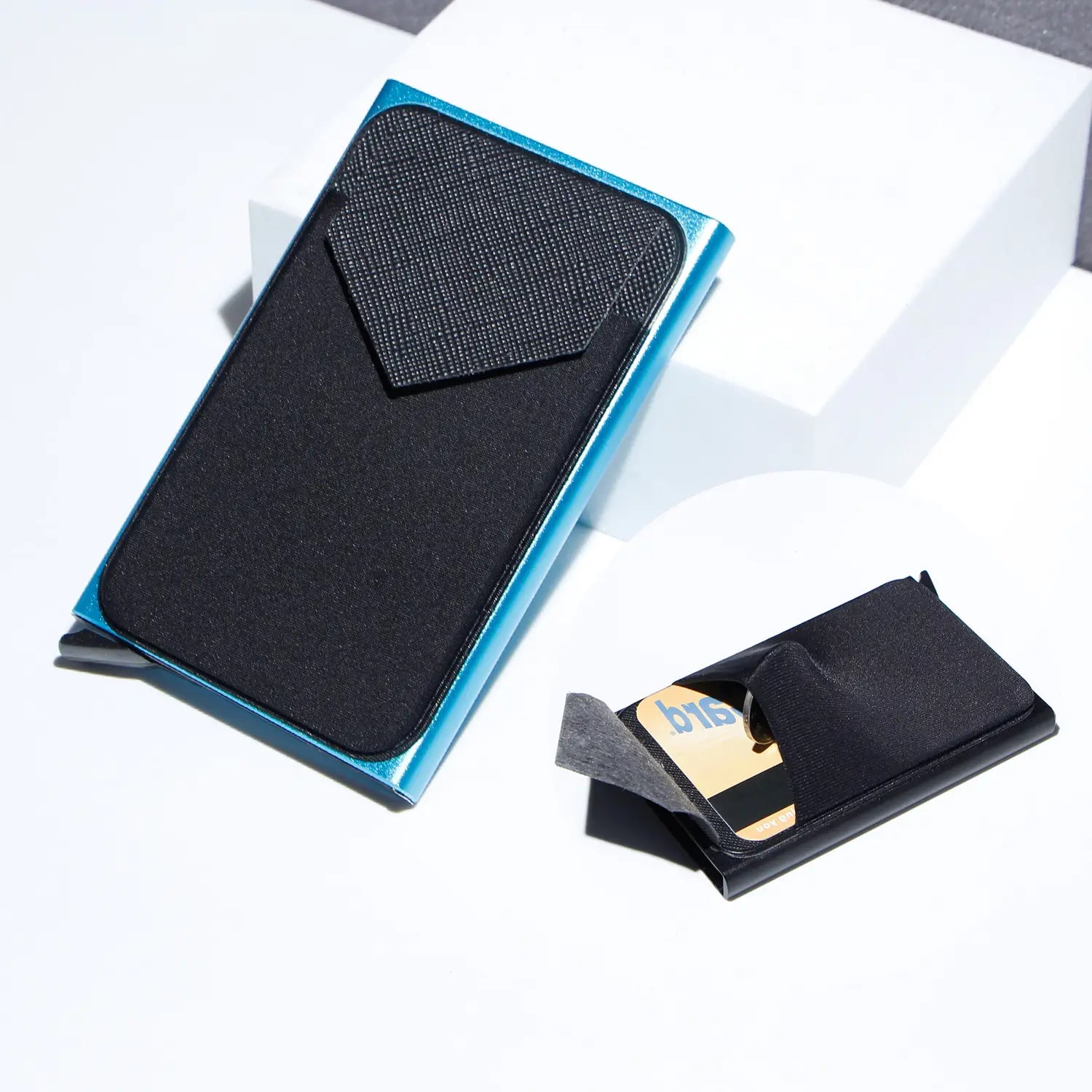 Blue metallic minimalist RFID blocking aluminum multi card wallet with black textured interior and a card slot.