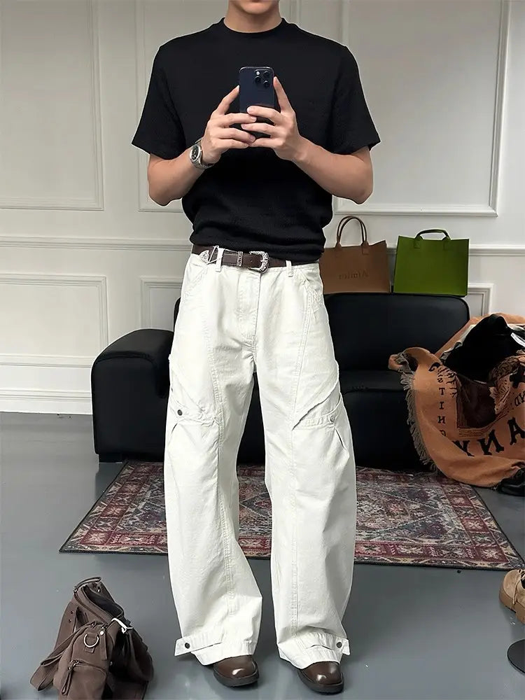 white wide-leg cargo pants made from durable fabric featuring multiple pockets and buttoned cuffs for a versatile casual look