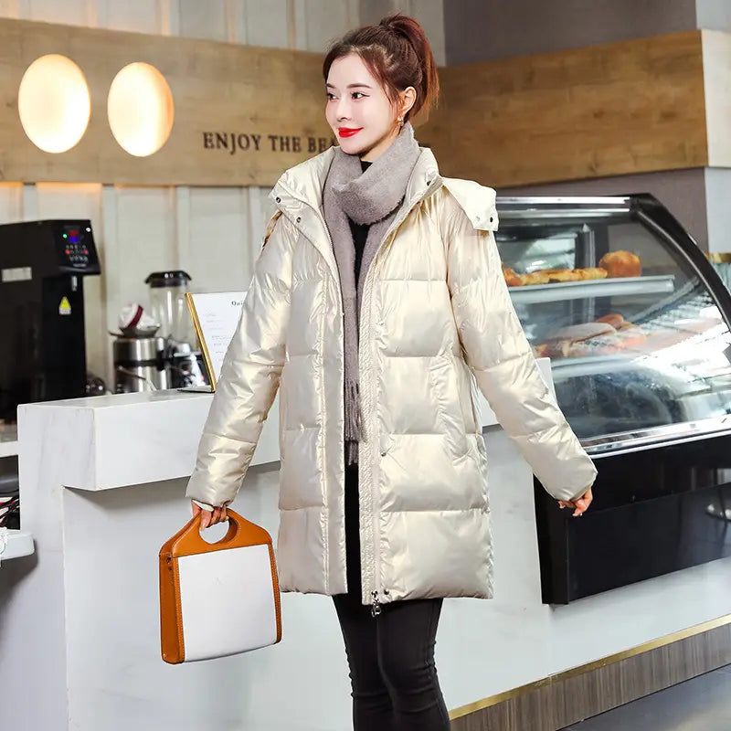 Glossy black plus size puffer jacket featuring a shiny metallic gold quilted design with an adjustable hood.