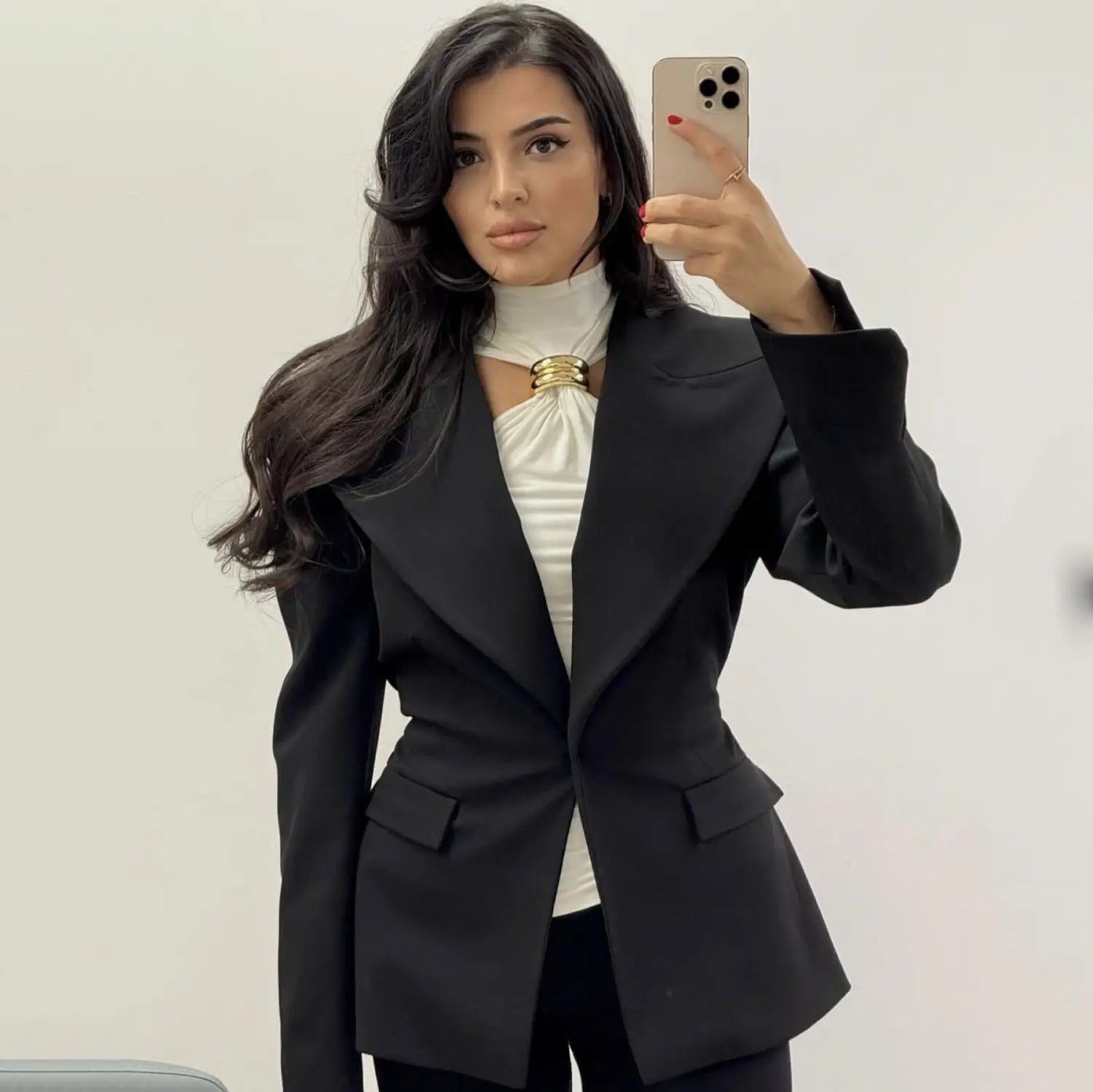 black tailored blazer featuring a gold-toned clasp at the neckline, styled with the gold ring halter stretch top.